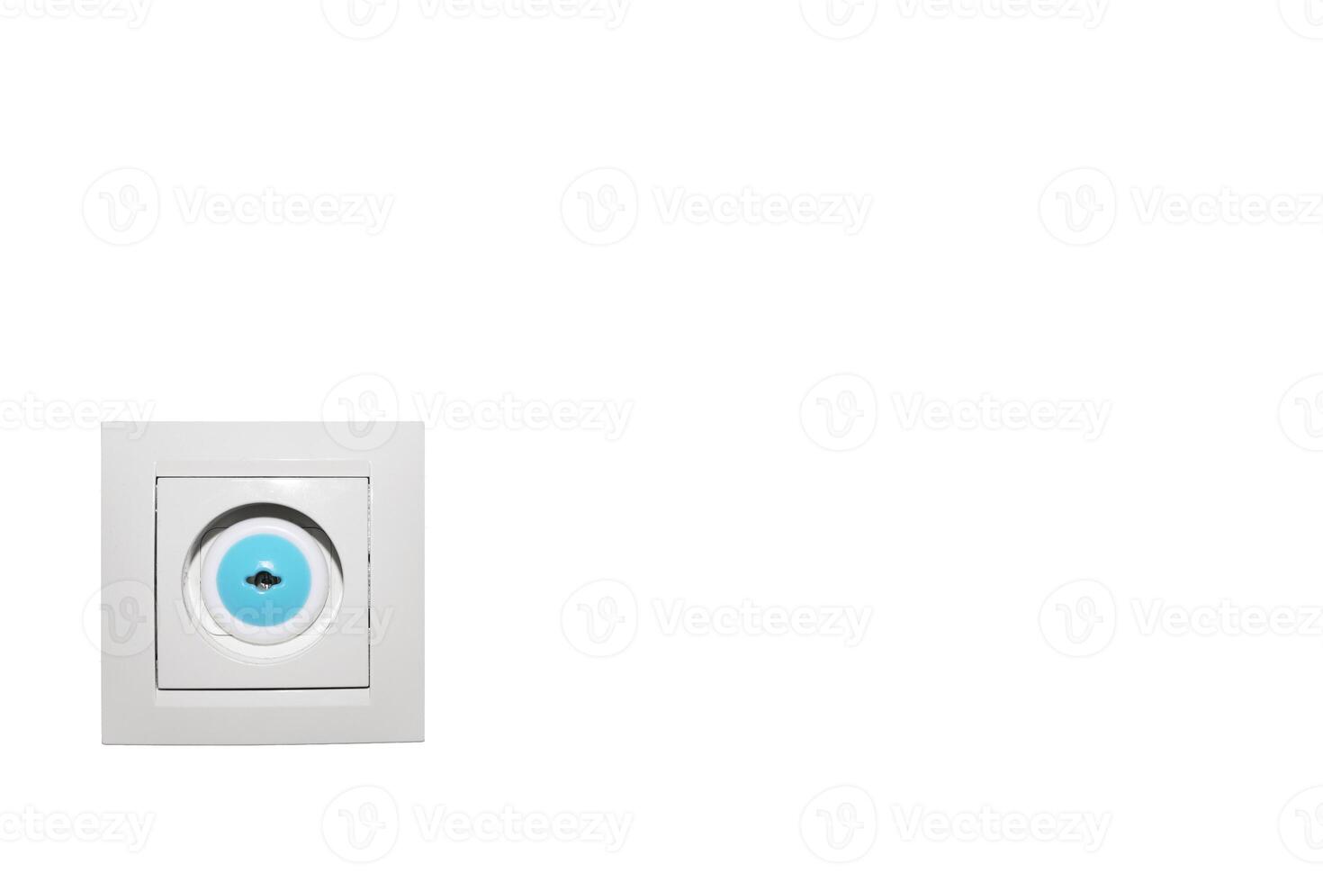 Electrical socket on white wall with plug and child protection. Copy space. photo