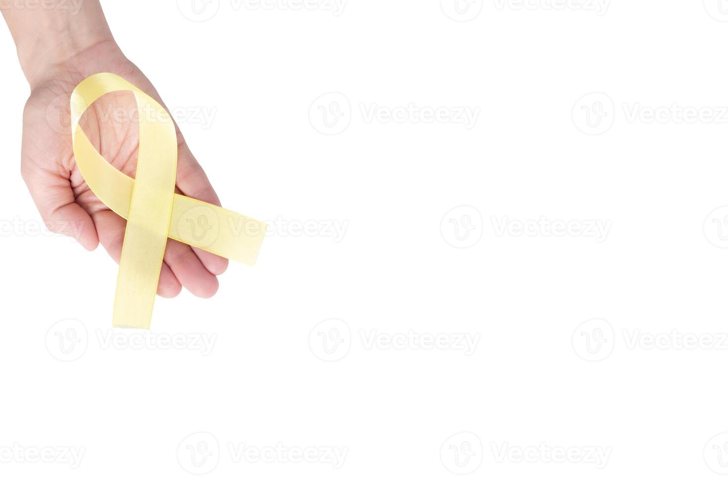 Yellow satin ribbon on the palm of a woman, isolated on a white background. Cancer awareness symbol, suicide prevention campaign. copy space photo