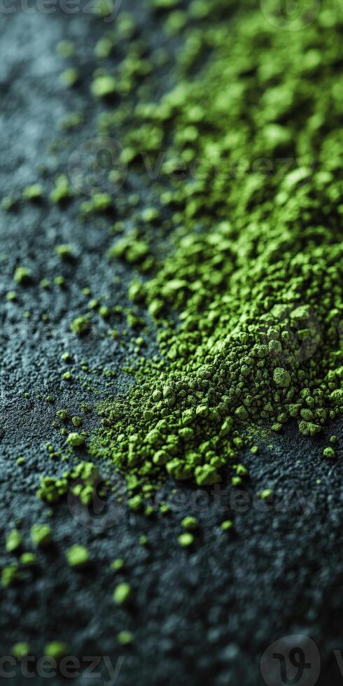 Moringa powder scattered on a dark surface highlighting its color photo
