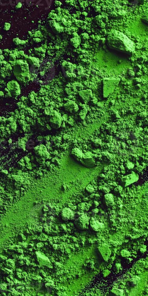 Moringa powder spread across a dark surface in vibrant green hues photo