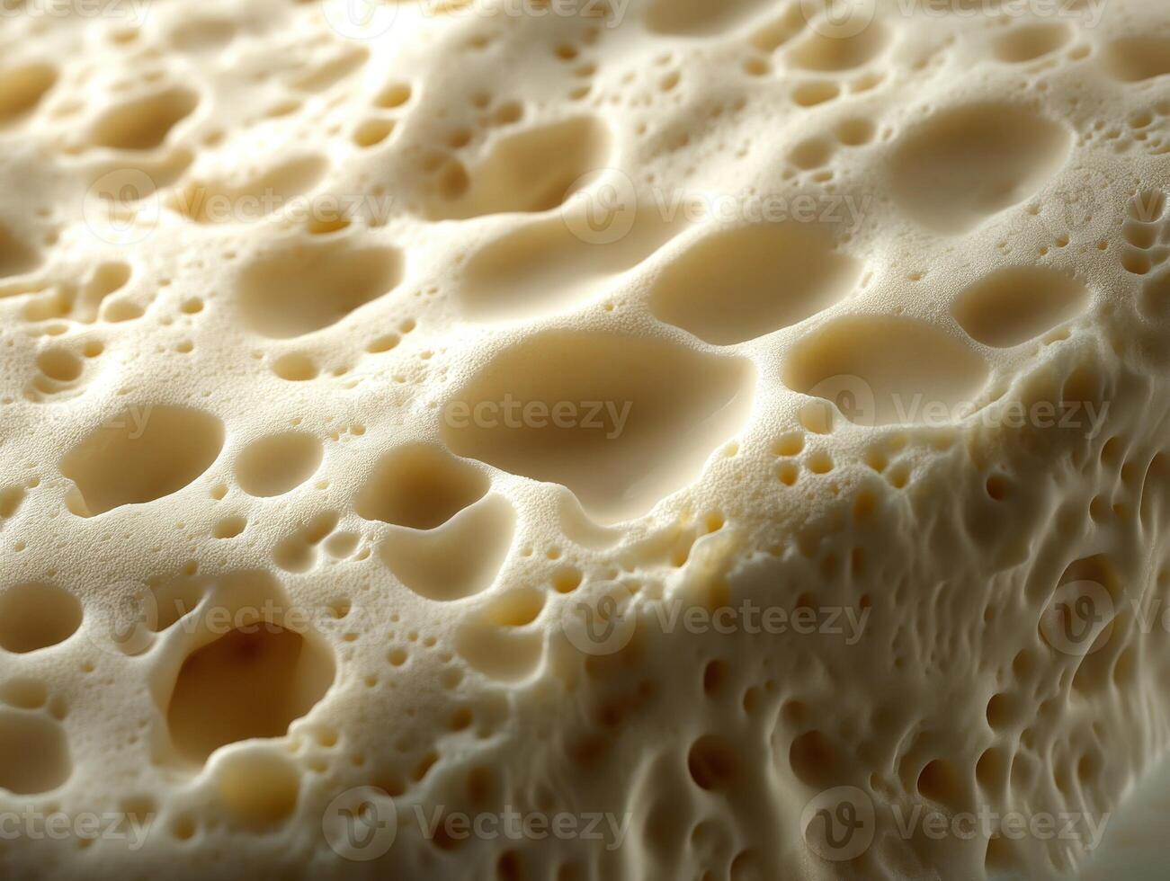 Soft cheese with creamy texture and airy bubbles during close-up photo