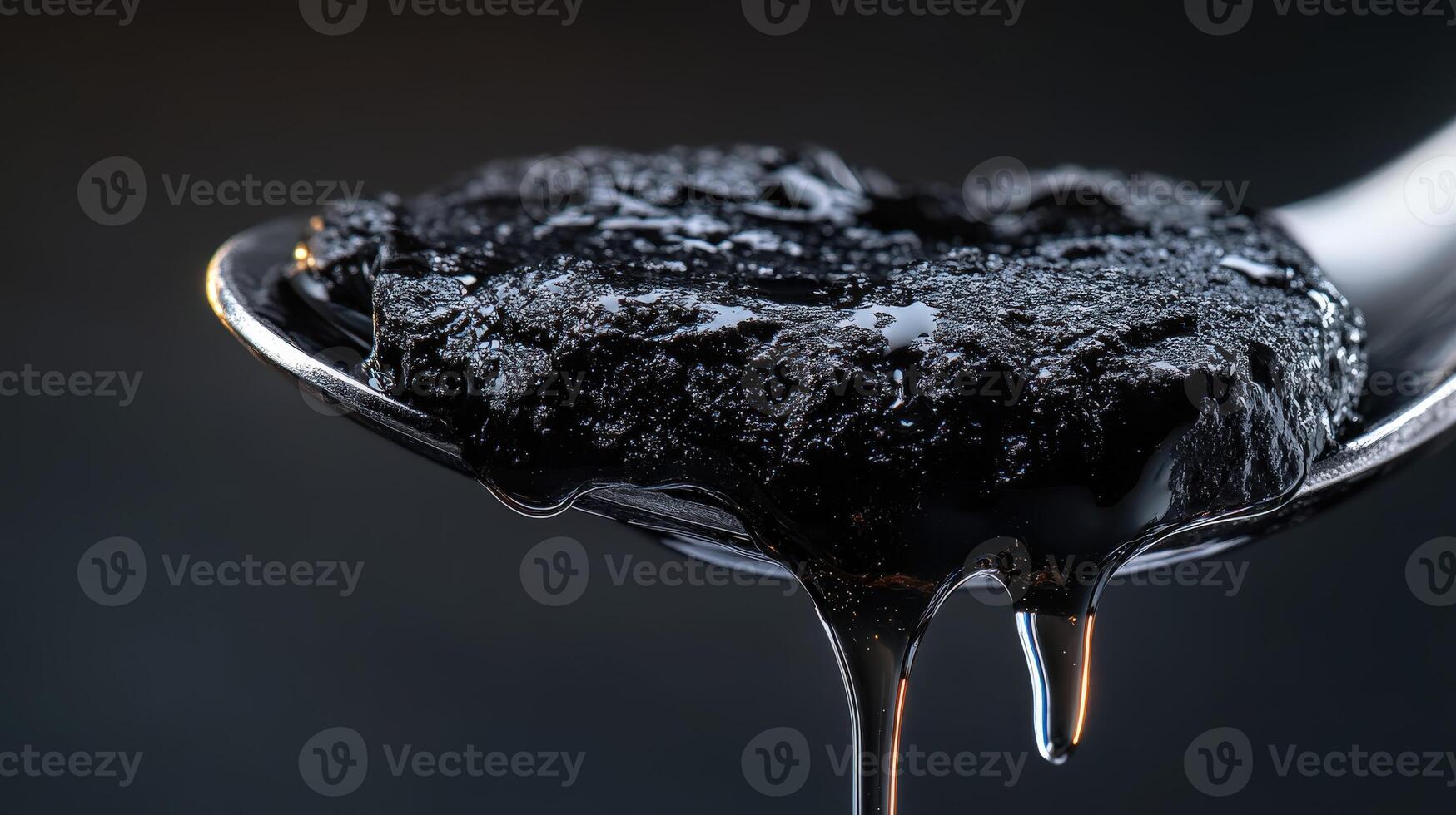 A spoon with a black substance on it photo