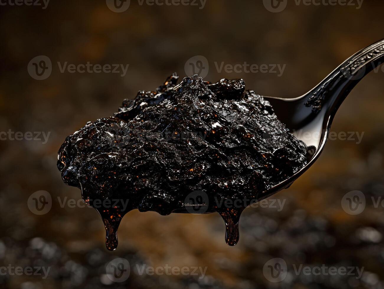 A spoon with a black substance on it photo