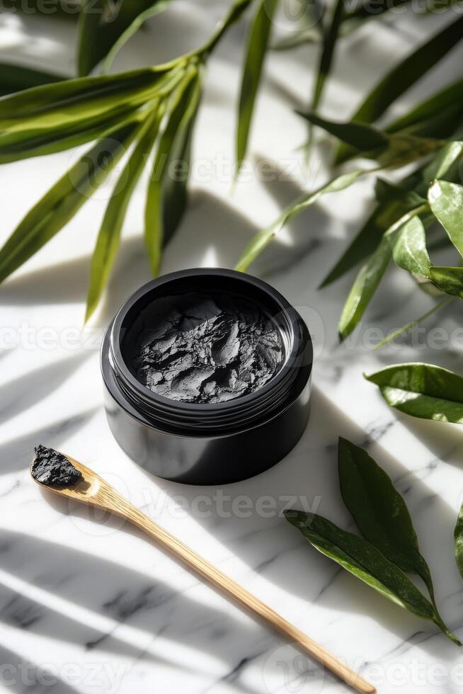 Natural shilajit preparation in a black container on marble surface photo