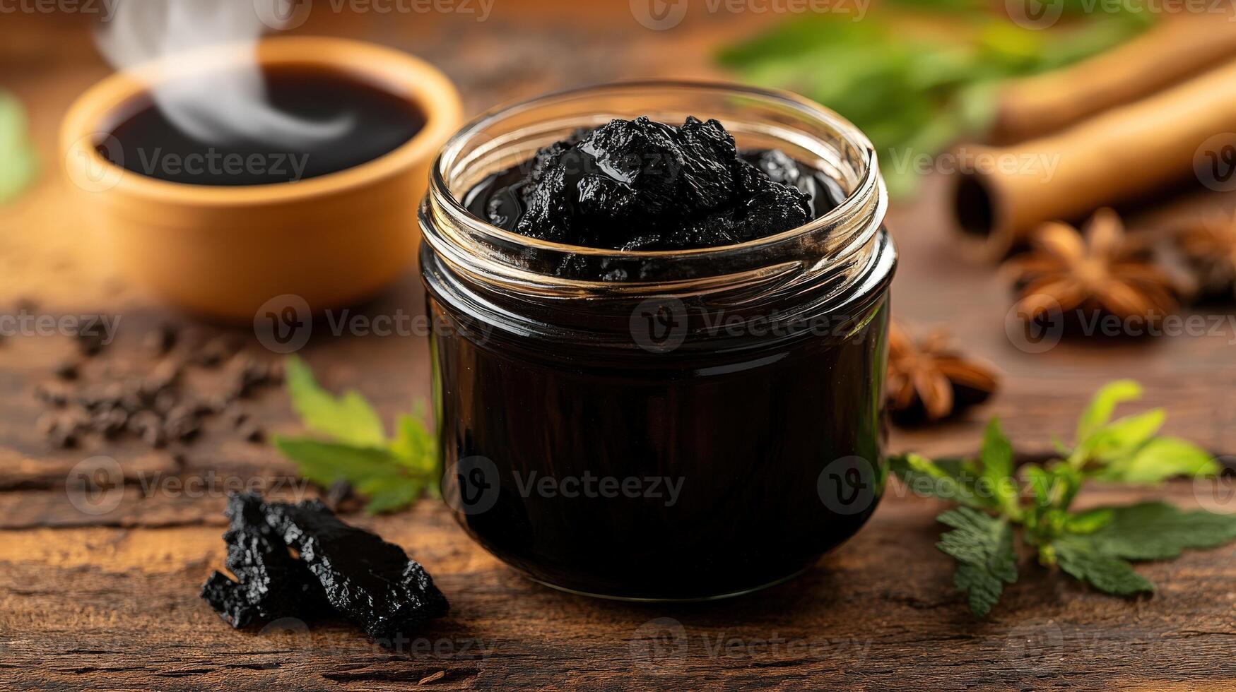 Shilajit resin in a glass jar with herbs and spices photo