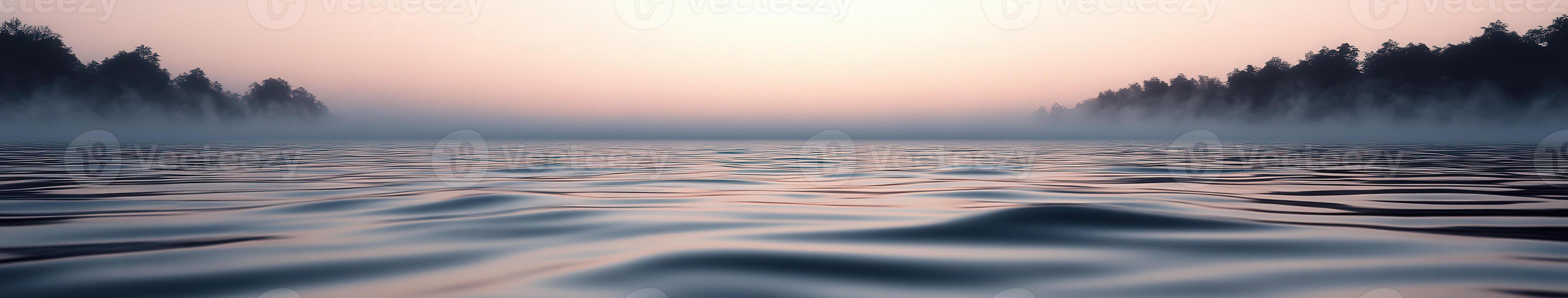 Calm river water at dawn surrounded by mist and trees photo