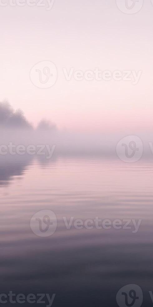Misty river water reflects soft morning light at dawn photo