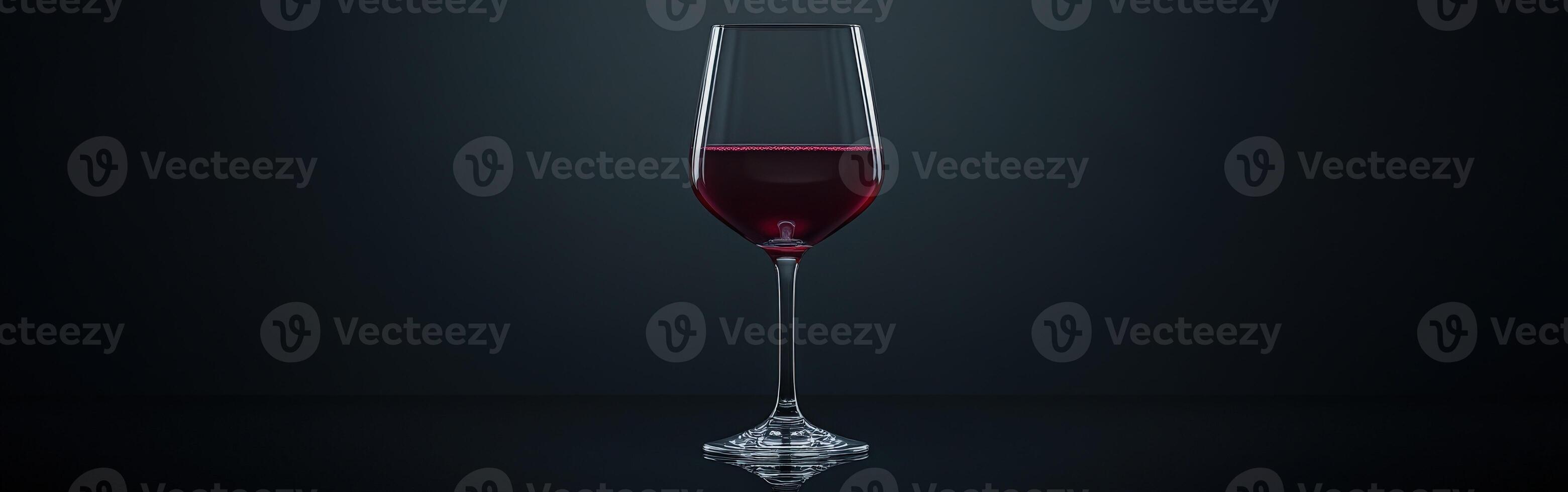Elegant red wine glass with rich liquid reflecting on a dark surface in a minimalist setting photo