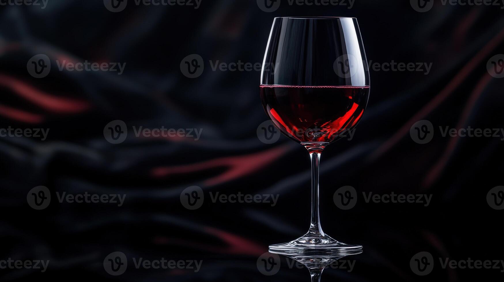 Elegant red wine glass set against a dark backdrop reflecting rich colors and textures photo