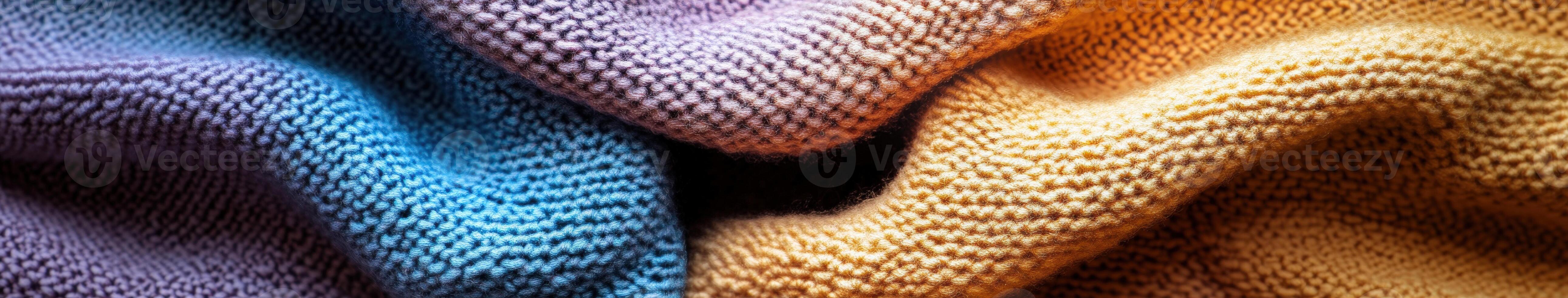 Soft textured yarn in vibrant shades of blue, purple, and yellow creating a cozy blanket display at a craft fair photo