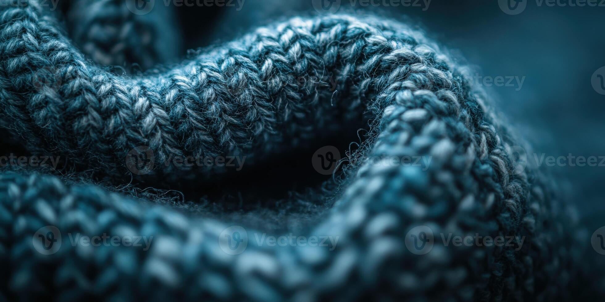 Close-up view of rich blue boucle fabric showcasing texture and intricate knit patterns in a cozy indoor setting photo