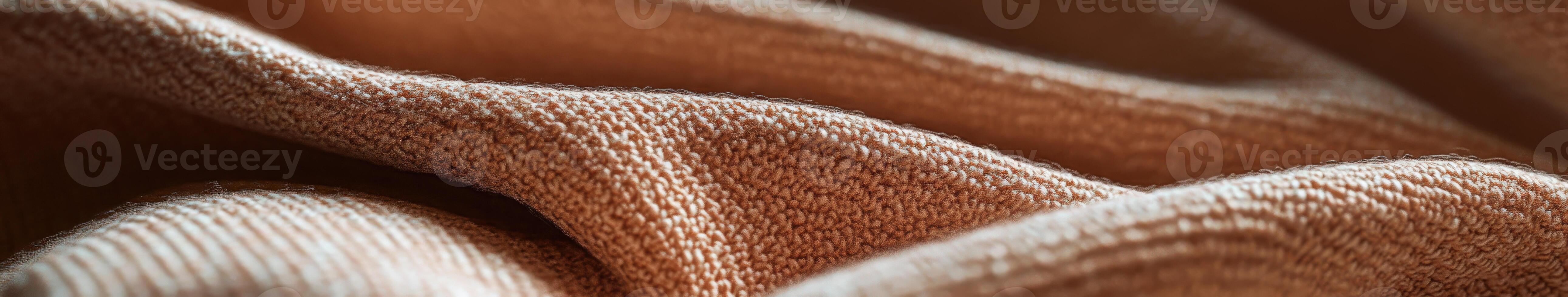 Boucle fabric showcases intricate texture and warmth in rich brown hues softly draped across a surface photo