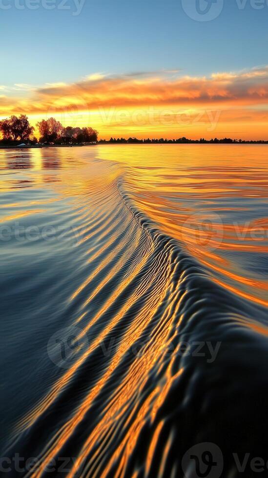 Sunset over the water with waves in the background photo