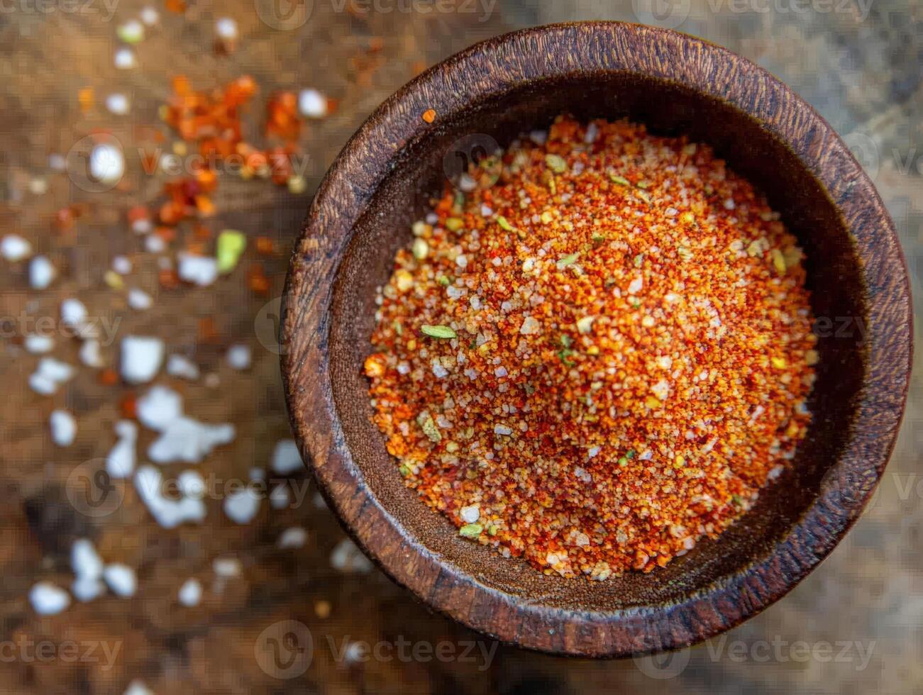 Exploring the vibrant flavors of tajin in a rustic wooden bowl on a kitchen countertop photo