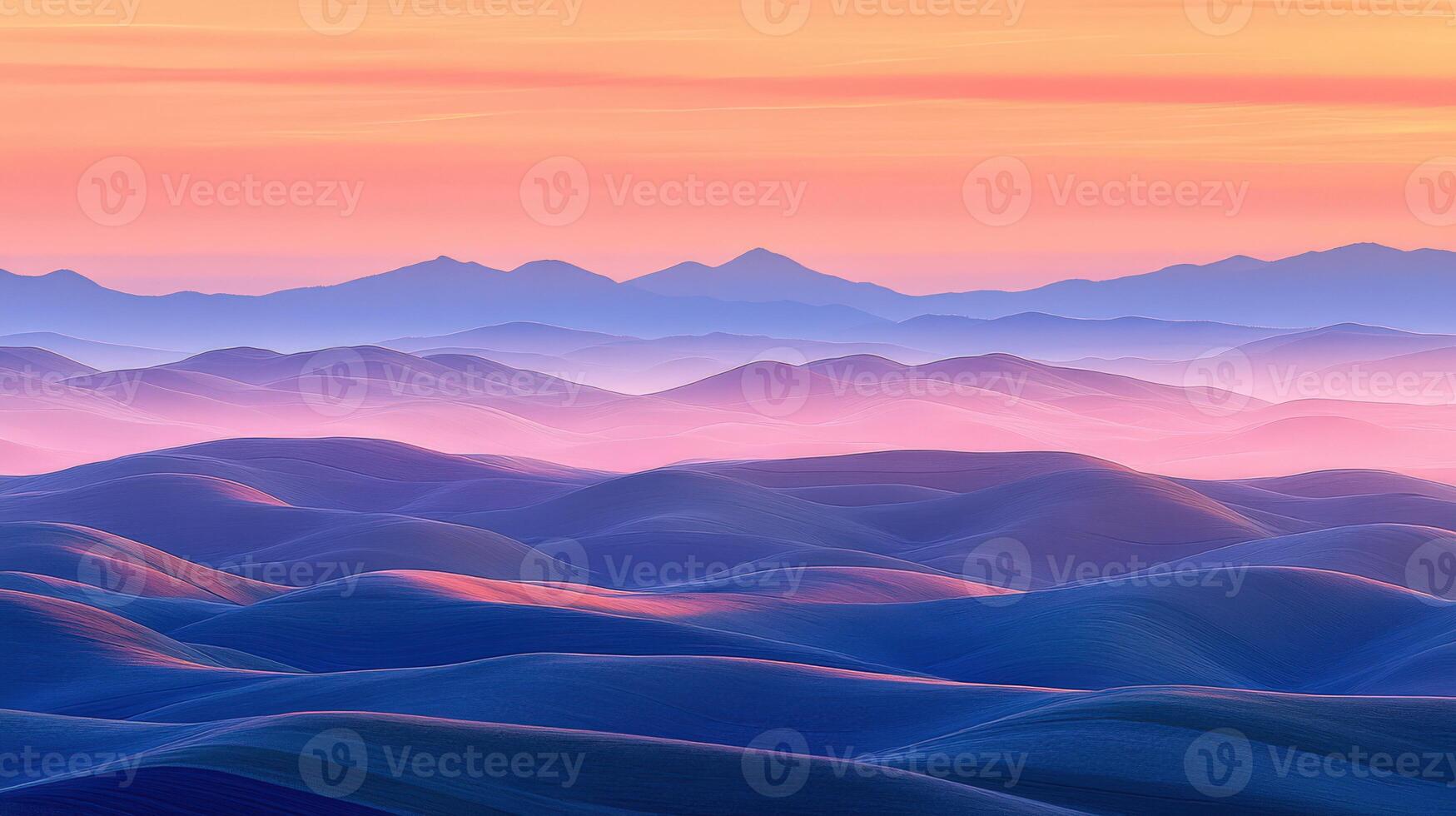 A colorful sunset over mountains and hills photo