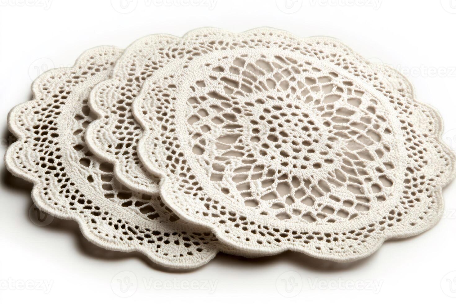Crocheted doilies forming elegant and intricate patterns are lying on white background photo