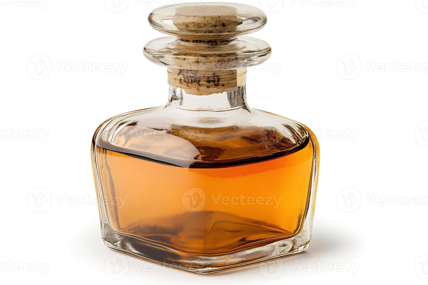 Crystal decanter containing amber liquid stands on white background photo