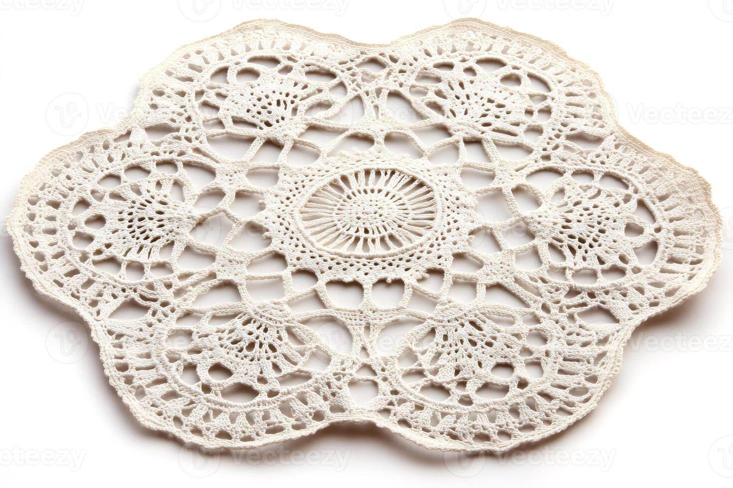 Vintage handmade crochet doily resting on white background photo