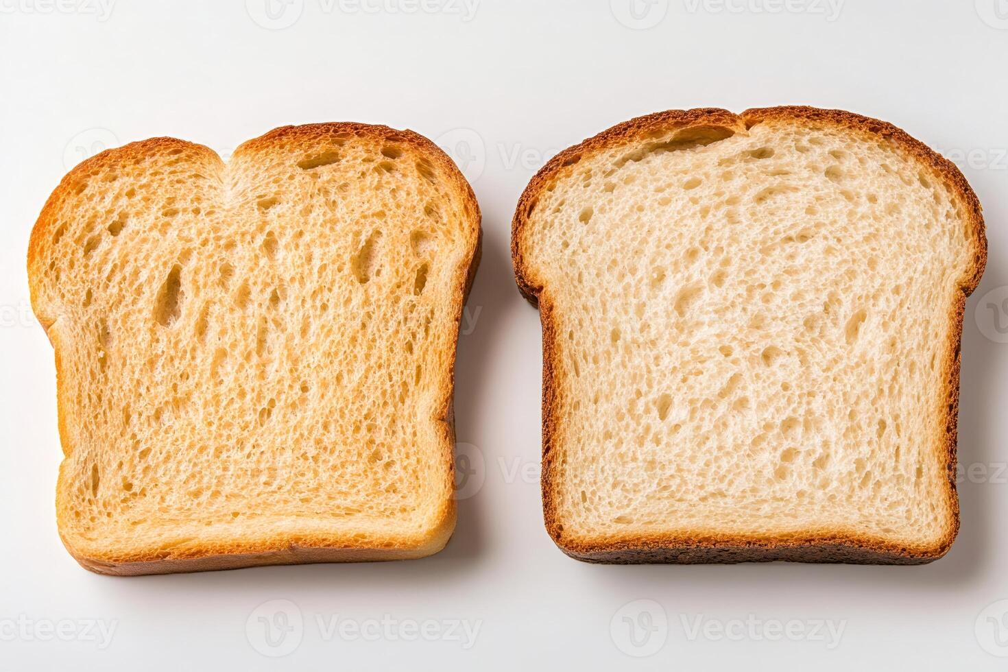 Two slices of bread showing different textures and colors on white background photo