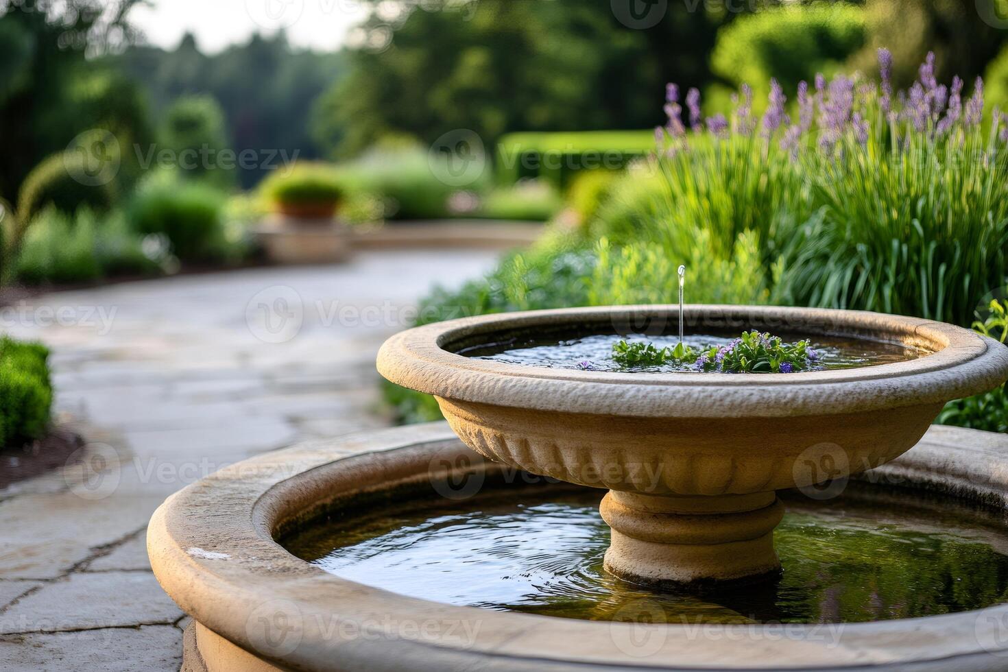 Water trickling in a fountain in a peaceful garden during summer photo
