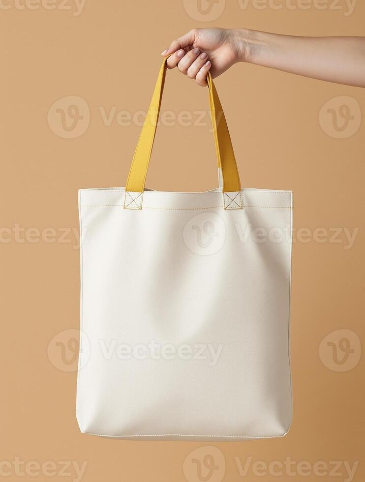 A white tote bag with yellow handles photo