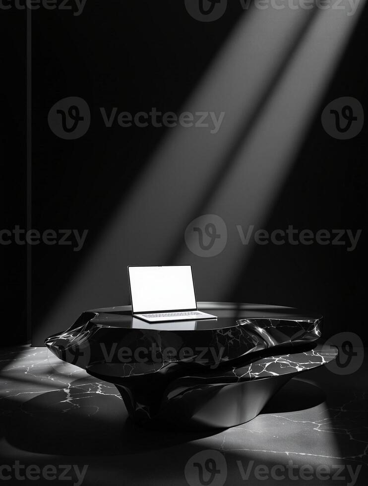 A black and white photo of a laptop on a table