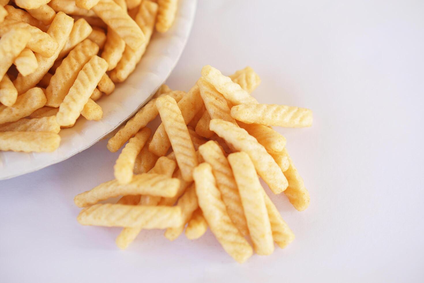 Prawn cracker sticks, Shrimp crisp rice snack on white background. Concept, traditional crunchy food snack appetizer. photo