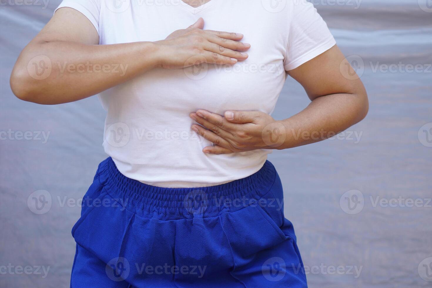 Close up woman uses hands to touch or massage her breast. Concept, self-checking breast cancer. Inspect abnormal of disease screening individually . Woman health care. photo
