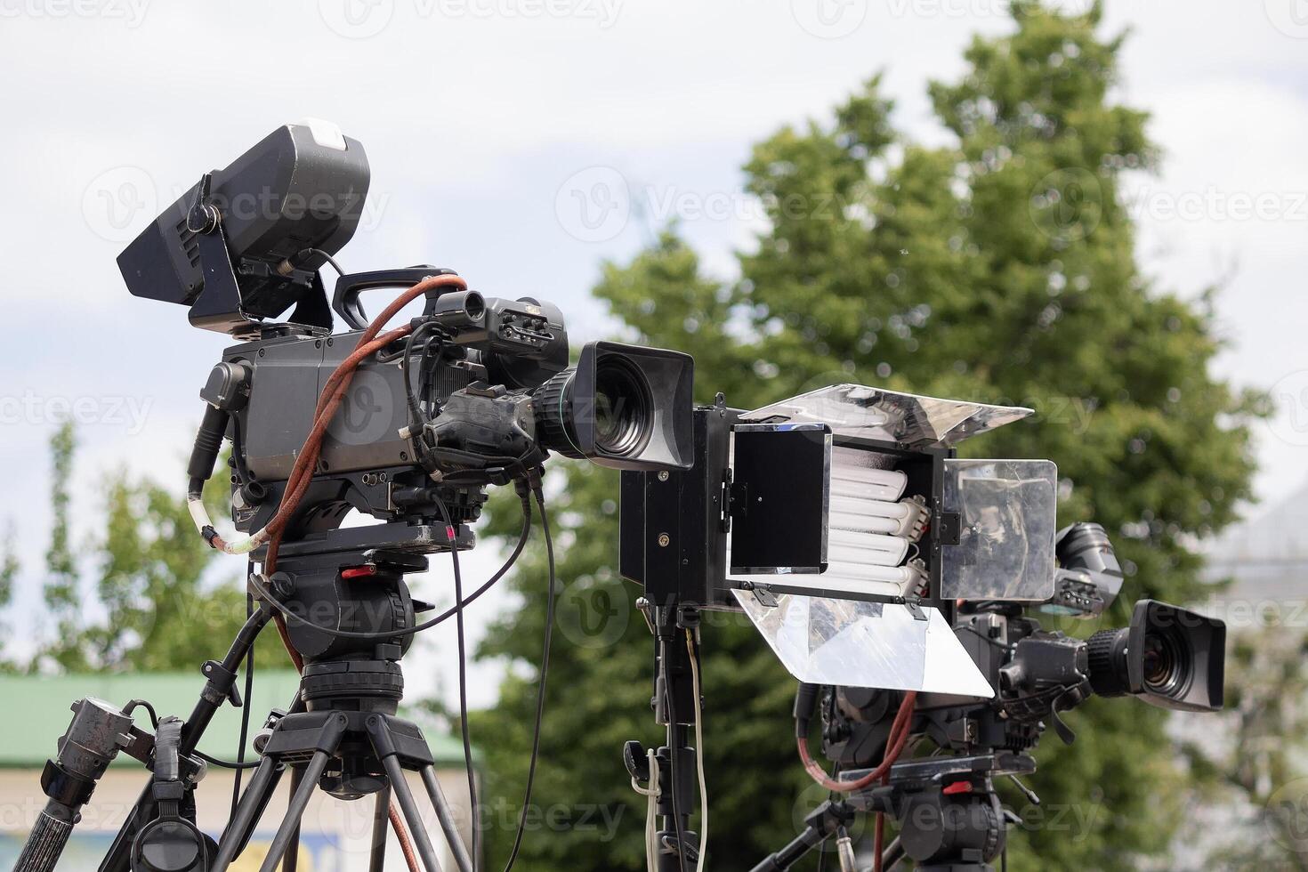 Professional TV camera filming event on the street photo