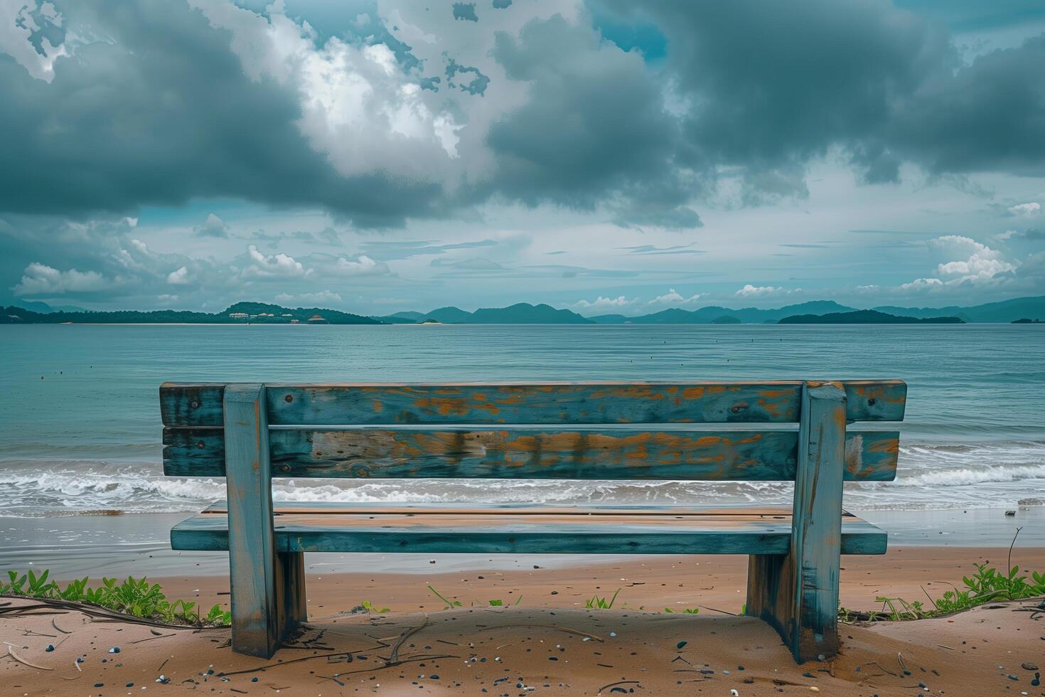 A bench sitting on a beach with a view of the ocean photo