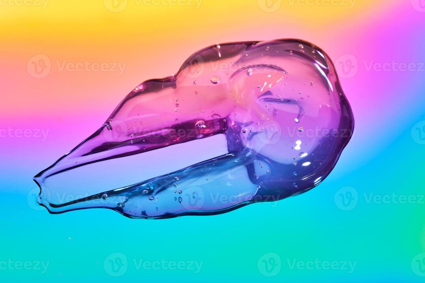 The texture of the cosmetic gel on a multicolored background. photo