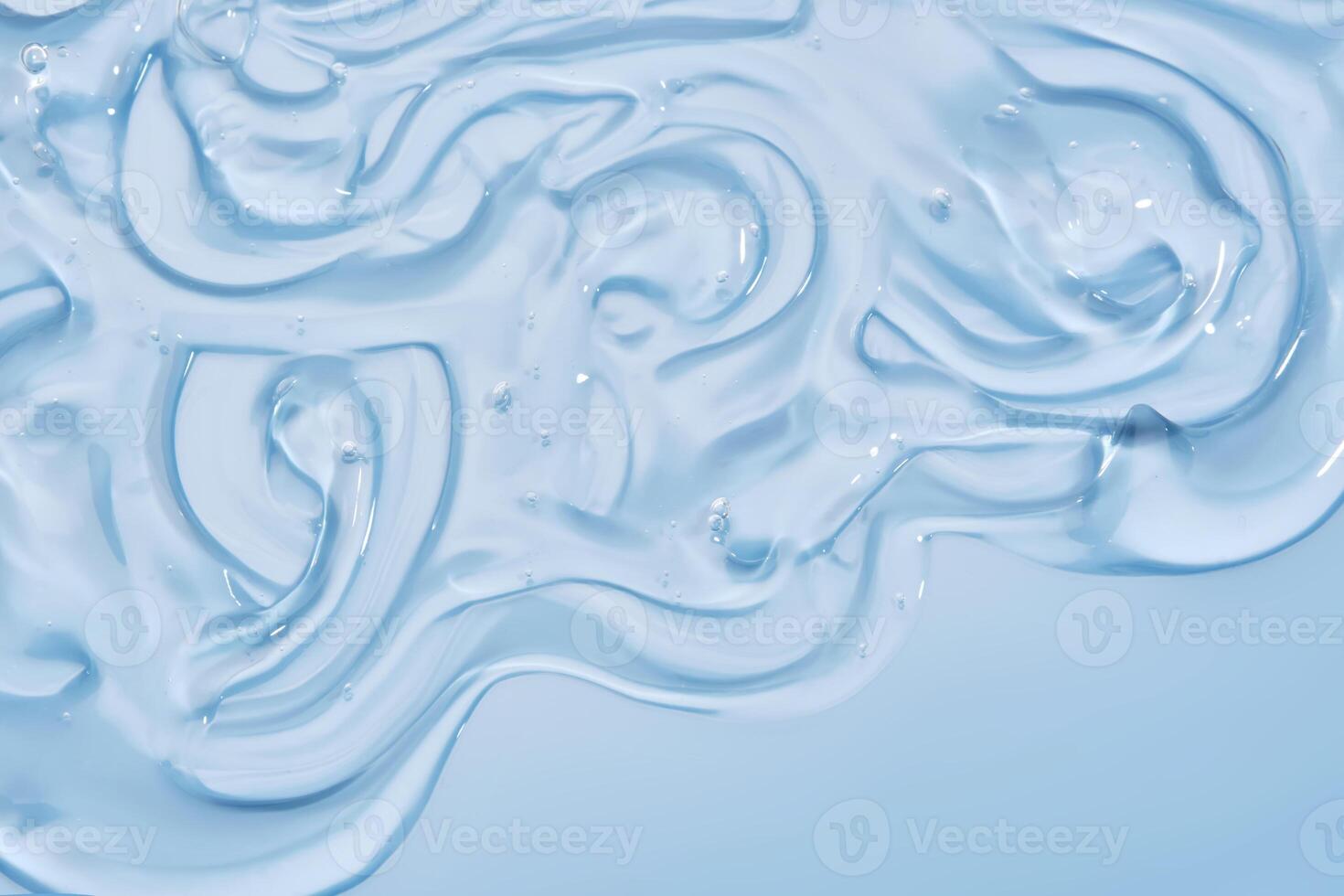The texture of the cosmetic gel on the blue background. photo