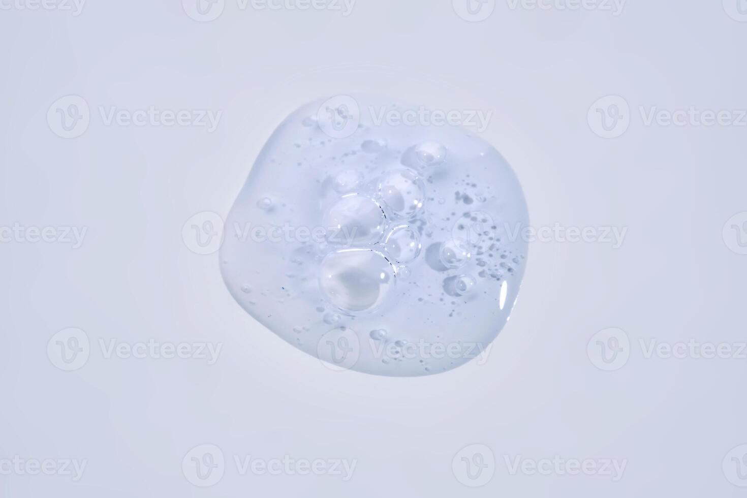 A drop of blue serum with bubbles. photo