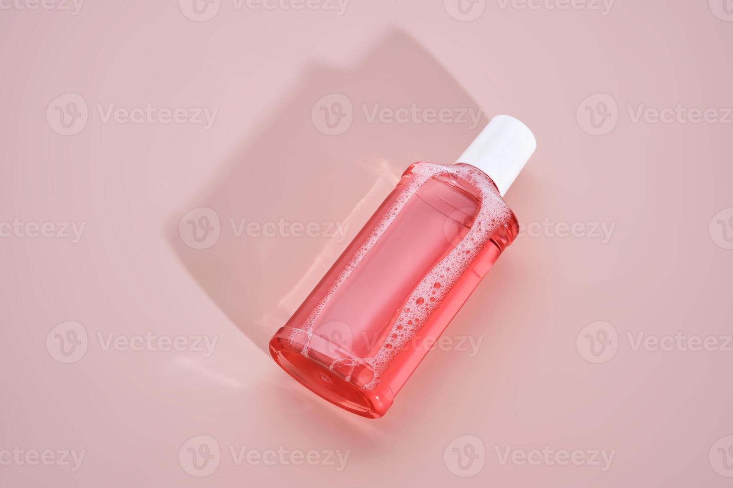 Pink mouthwash on a pink background. photo