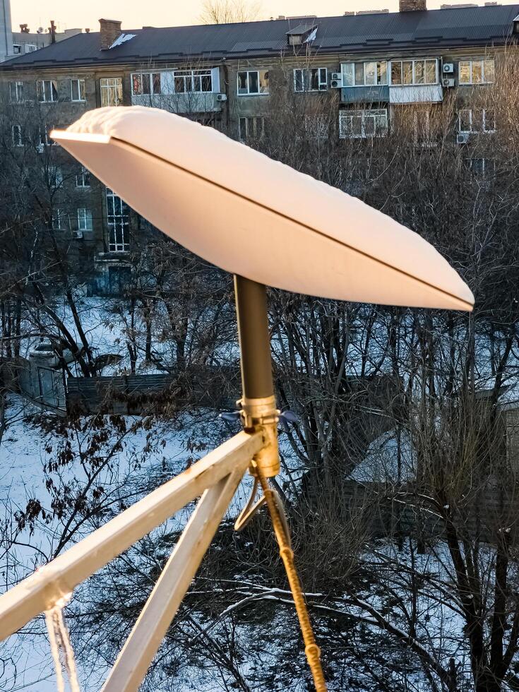 SpaceX's Starlink satellite dish is covered in snow. Starlink is disabled and does not melt snow photo