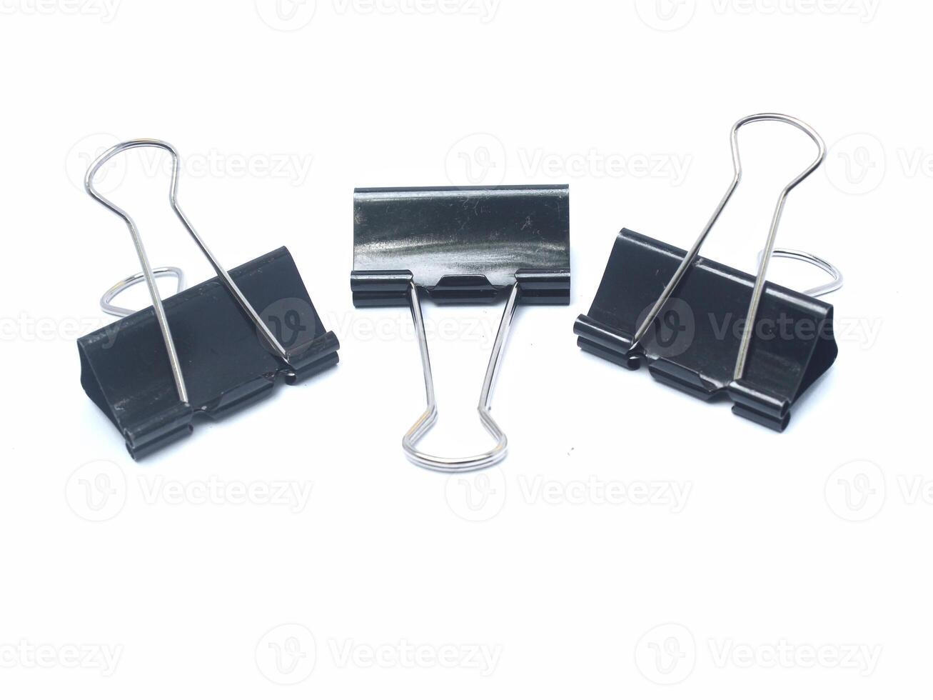 collection of large black paper clips isolated on white background photo