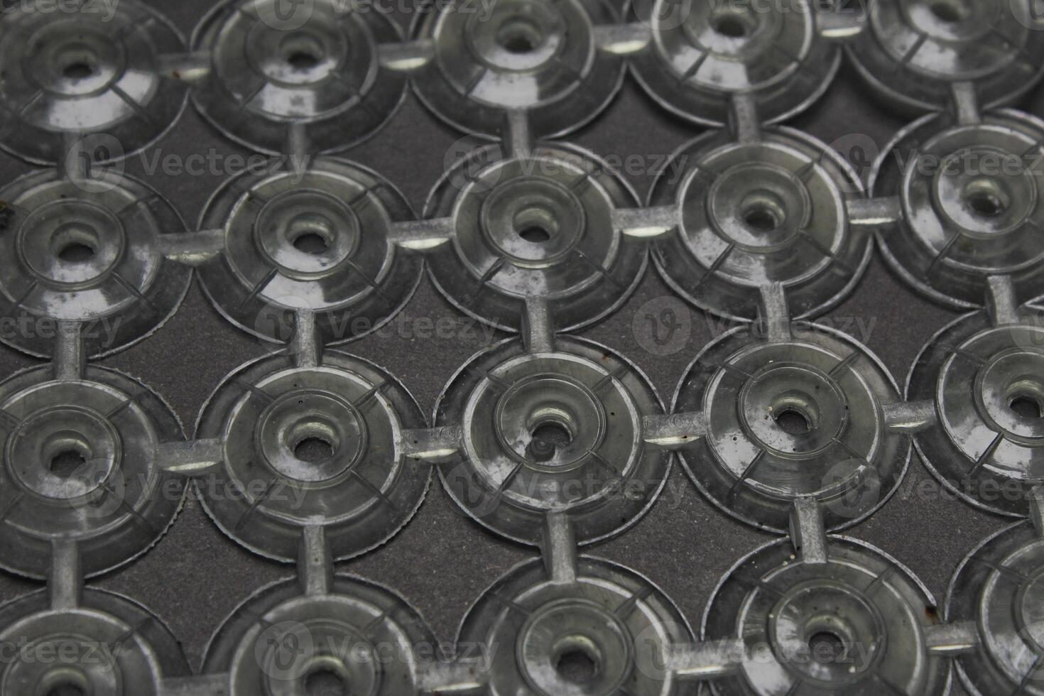 circular pattern of isolated plastic, placed on a black surface. photo