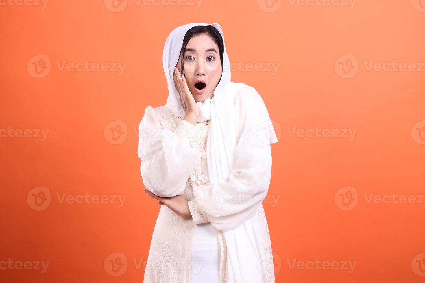 Surprised reaction of a woman wearing a hijab, looking astonishe photo