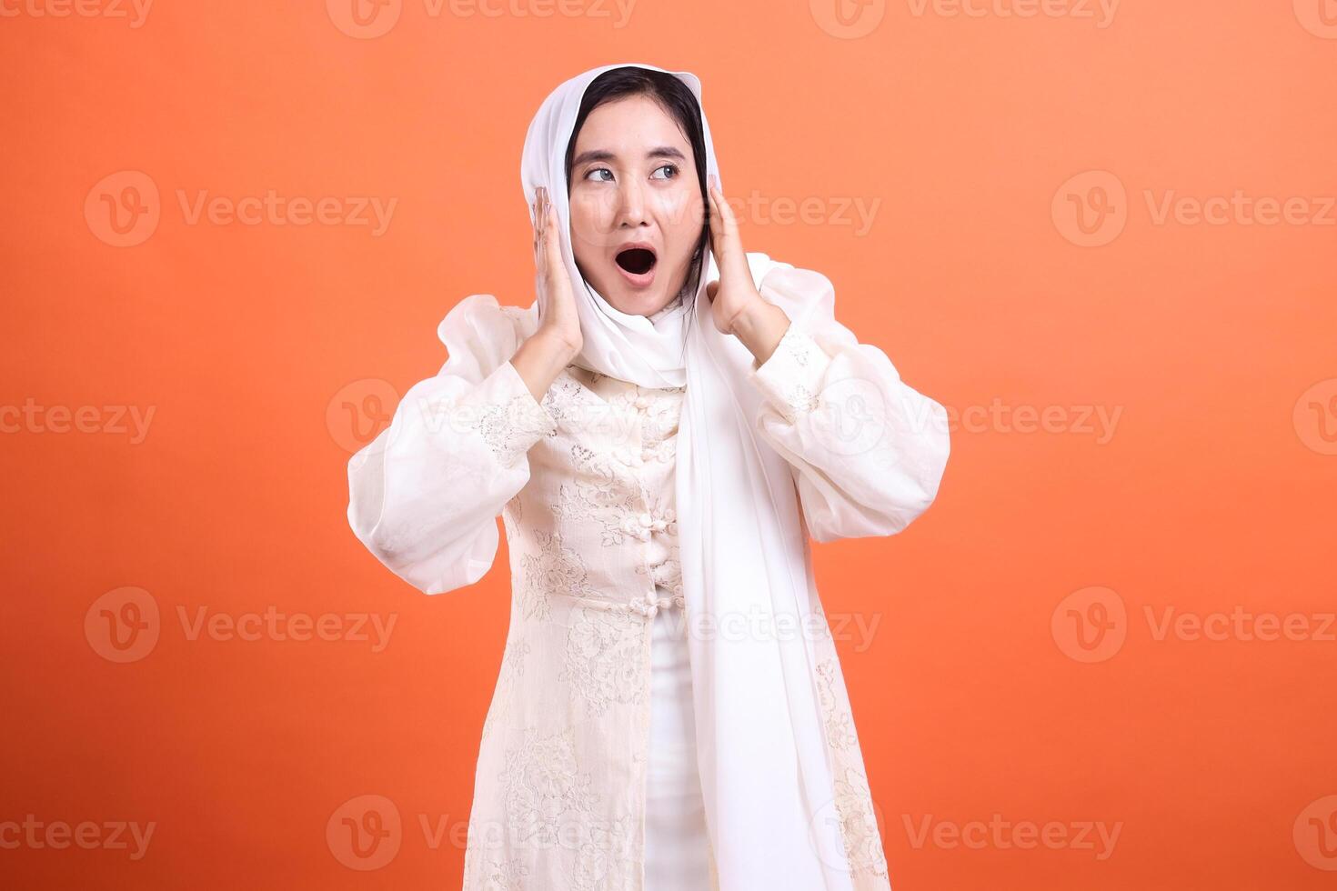 Startled Woman in Hijab with wide eyes and open mouth, seemingly photo