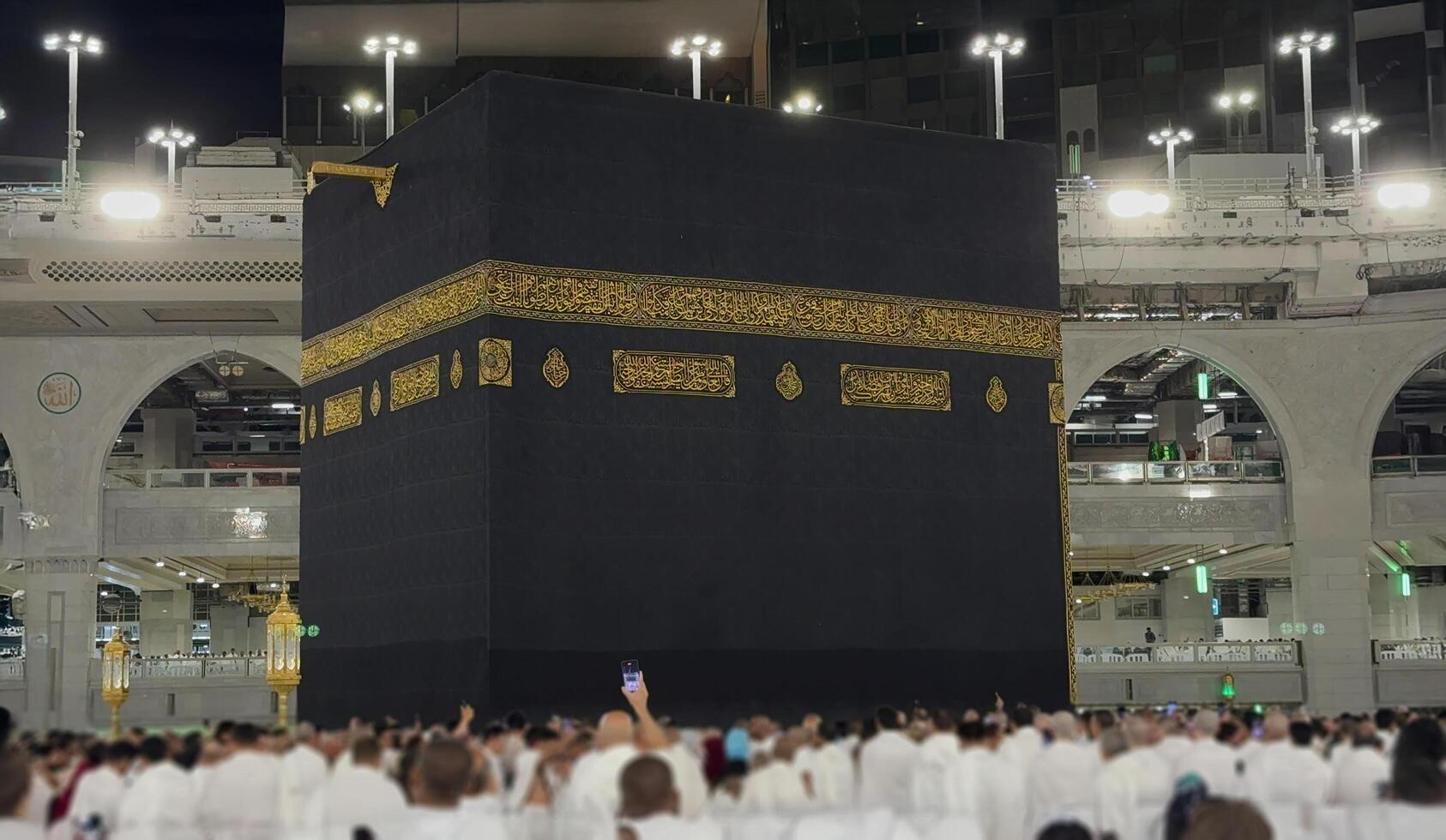 Muslim pilgrims perform Tawaf around the Kaaba after dawn prayer at Masjid al-Haram in Makkah. Translation. Praise be to Allah Who created the heavens and the earth and made the darkness and the light photo