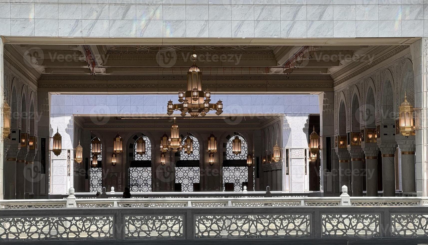 A Muslim pilgrim praying inside the grand Masjid al-Haram in Mecca, Saudi Arabia. The holy Kaaba, Islamic architecture, and religious symbols create a serene atmosphere during Hajj or Umrah photo