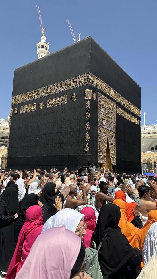 Muslim pilgrims perform Tawaf around the Kaaba after dawn prayer at Masjid al-Haram in Makkah. Translation. Praise be to Allah Who created the heavens and the earth and made the darkness and the light photo
