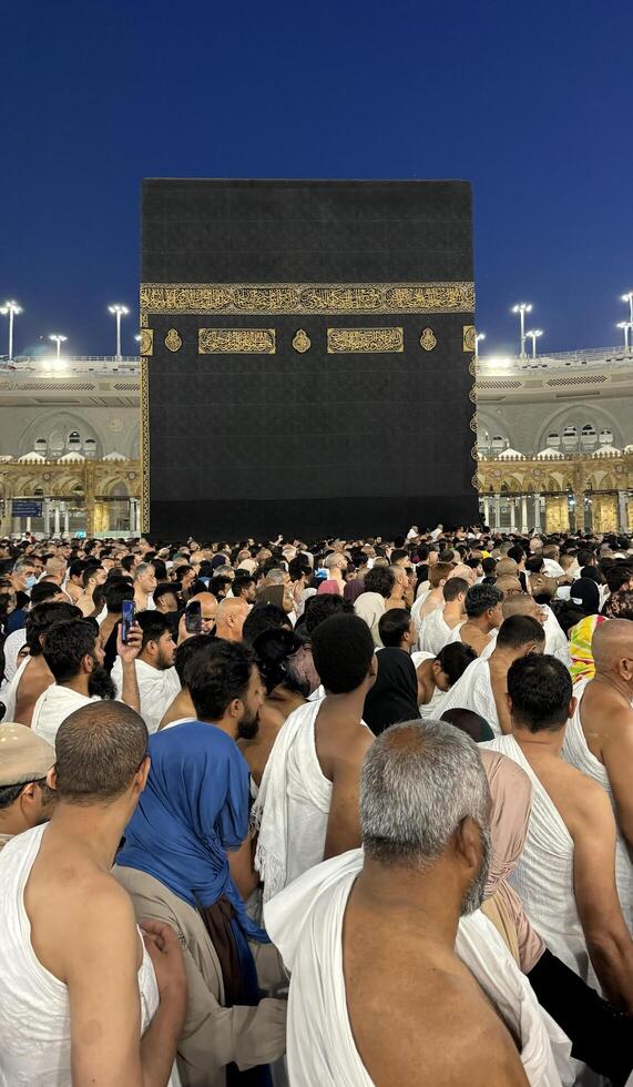 Muslim pilgrims perform Tawaf around the Kaaba after dawn prayer at Masjid al-Haram in Makkah. Translation. Praise be to Allah Who created the heavens and the earth and made the darkness and the light photo