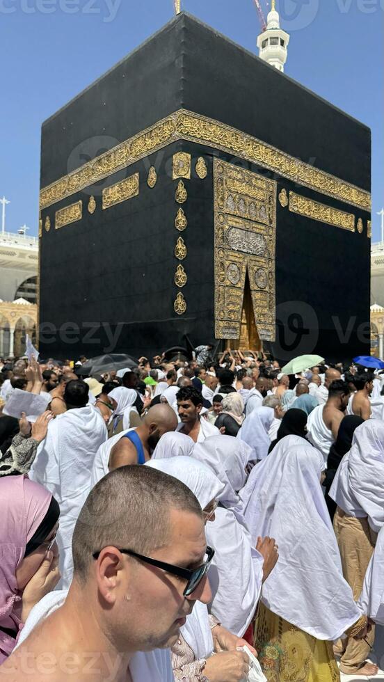 Muslim pilgrims perform Tawaf around the Kaaba after dawn prayer at Masjid al-Haram in Makkah, Saudi Arabia. Muslims worldwide face the Kaaba in prayer, symbolizing unity and devotion in Islam photo