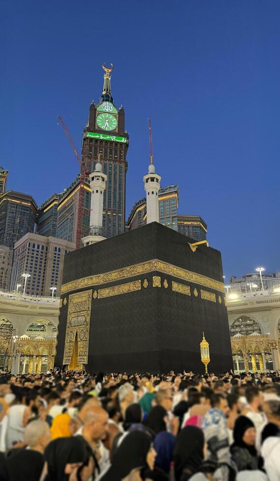 Muslim pilgrims perform Tawaf around the Kaaba after dawn prayer at Masjid al-Haram in Makkah. Translation. Praise be to Allah Who created the heavens and the earth and made the darkness and the light photo