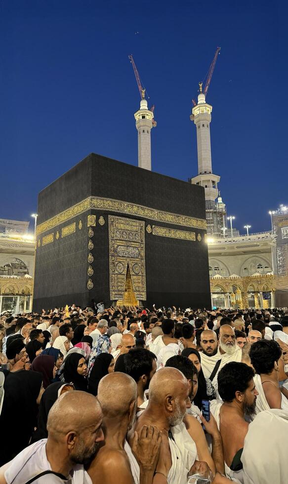 Muslim pilgrims perform Tawaf around the Kaaba after dawn prayer at Masjid al-Haram in Makkah. Translation. Praise be to Allah Who created the heavens and the earth and made the darkness and the light photo