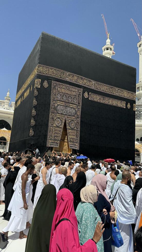 Muslim pilgrims perform Tawaf around the Kaaba after dawn prayer at Masjid al-Haram in Makkah. Translation. Praise be to Allah Who created the heavens and the earth and made the darkness and the light photo