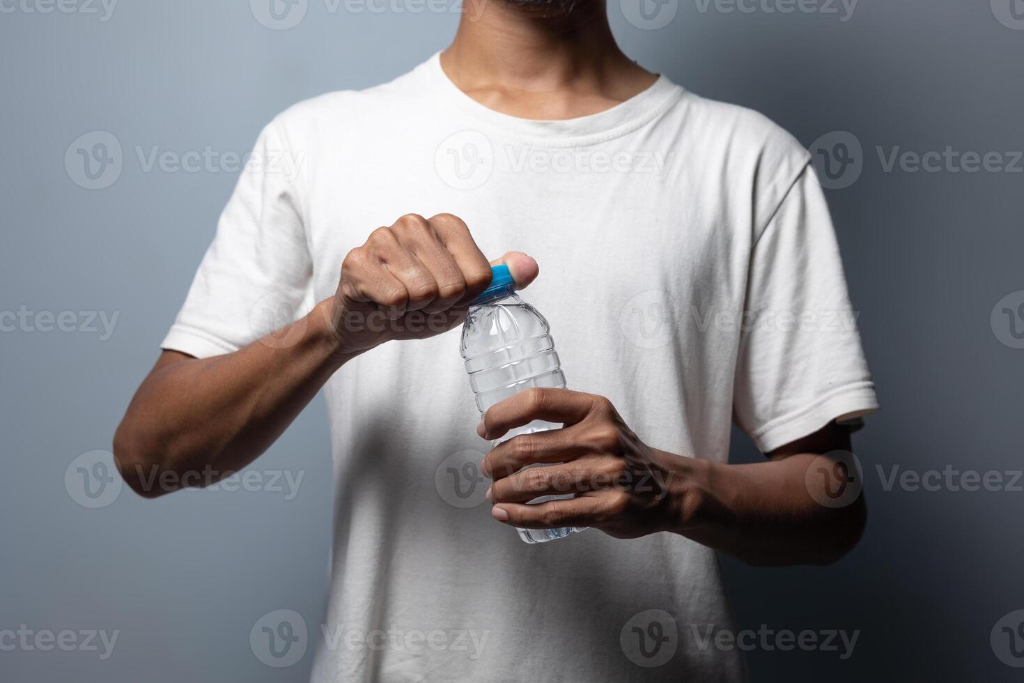 A man holding a plastic bottle of water photo