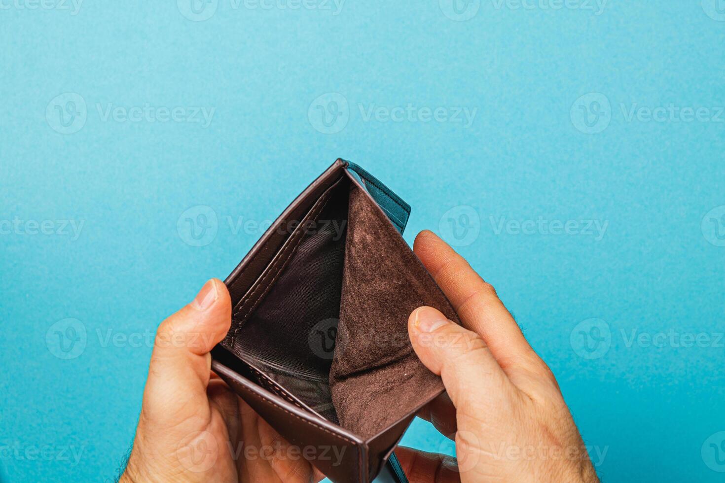 Struggling businessman,, examines empty wallet amid financial crisis photo