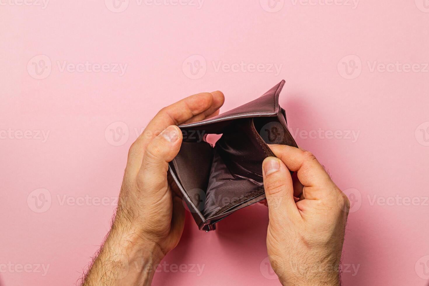 Desperate search for cash in an empty wallet during financial crisis photo